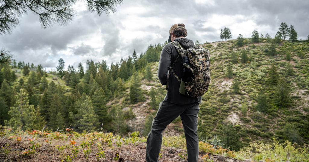 Eberlestock holiday gift guide product flat-lay with packs, blades, and field gear