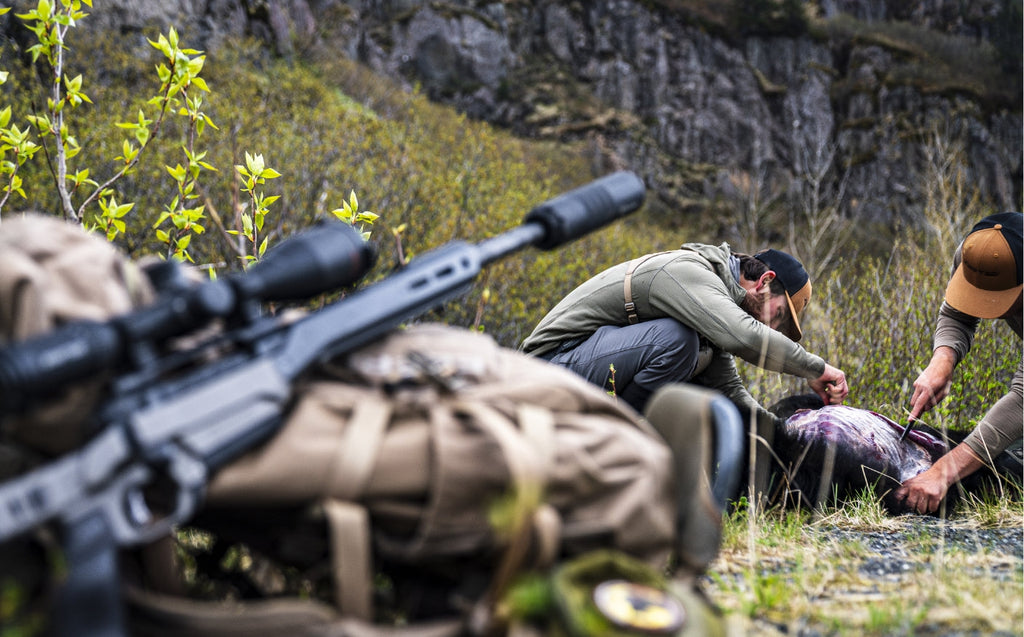 Hunter glassing a ridgeline with an Eberlestock pack during spring bear season